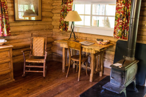Wood-fired stove and desk in the bedroom at Dining Cabin 6 | Dubois Wyoming Lodging | CM Ranch