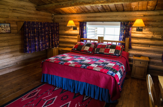 The queen bed in Hill Cabin 1 | Wyoming Guest Ranch | CM Ranch