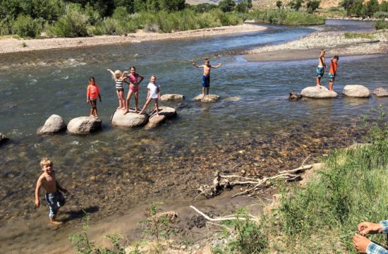 Family plays in the river at CM Ranch in Dubois, WY | Dude Ranch Wyoming Family