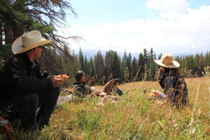 Guests on a horseback riding trip in Wyoming take a break for lunch near CM Ranch in Dubois WY
