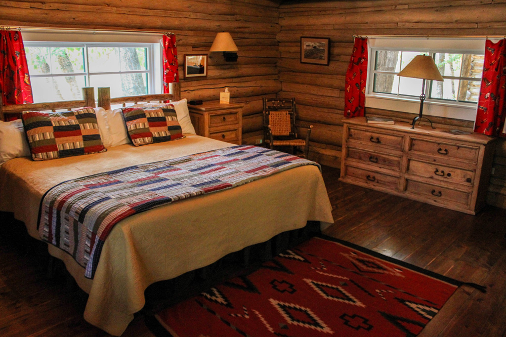 Queen bed, dresser and chair in Dining Cabin 4 | Dude Ranch Near Yellowstone | CM Ranch