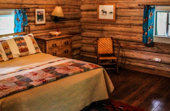 Queen bed, dresser and chair in Dining Cabin 5 | Family Dude Ranch Vacations | CM Ranch