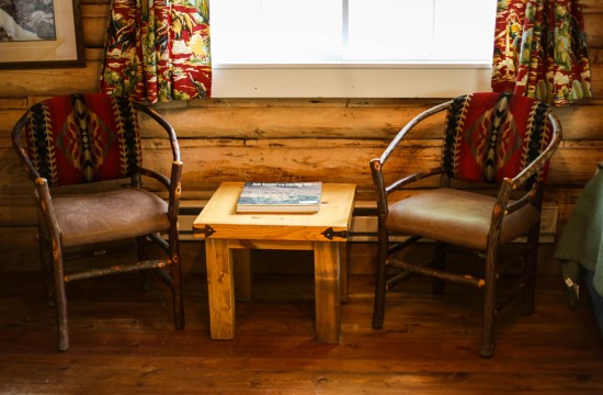 Two chairs and a side table at Dining Cabin 6 | Dubois Wyoming Lodging | CM Ranch