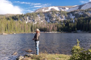 A person stands fishing along the bank of a river near CM Ranch in Dubois, WY | Wyoming dude ranch