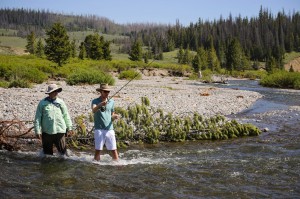 Two men fish in a river near CM Ranch in Dubois, WY | Wyoming dude ranch