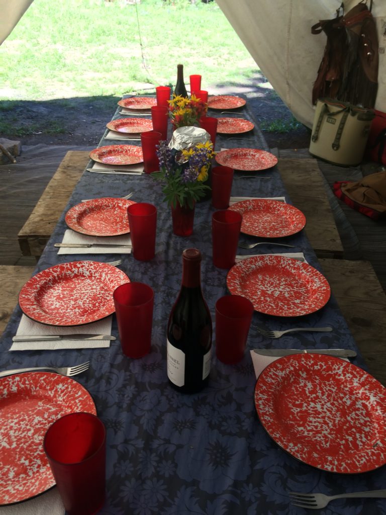 A table is set for dinner on a pack trip horseback riding in Wyoming near CM Ranch