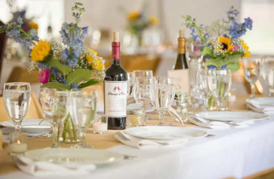 A formal table set with wine bottles for a wedding ceremony at CM Ranch in Dubois WY | dude ranch Jackson Hoe