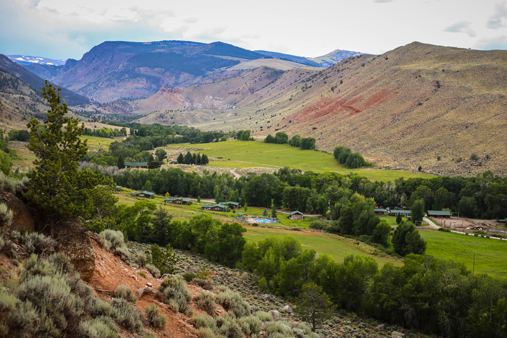 A view of the ranch building from a hill above at CM Ranch in Dubois, WY | Jackson Hole Wyoming horseback riding