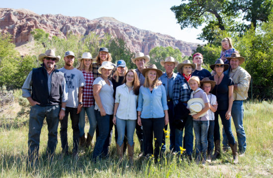 A large family gathering pauses for a portrait at CM Ranch in Dubois, WY | affordable family dude ranch vacations