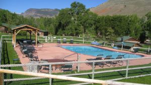 Pool area at CM Ranch with deck chairs and a gazebo